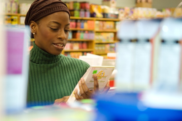 woman readiing label in store