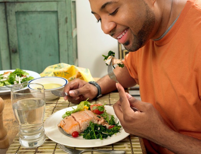 man eating a salmon salad for lunch