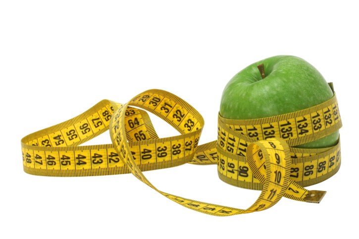green apple wrapped in a tape measure