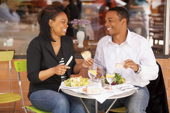 young african american couple eating at a restaurant 