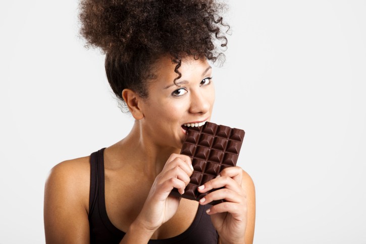 woman eating a big bar of chocolate