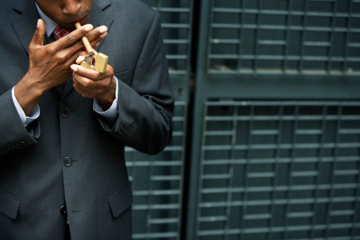 Businessman Lighting a Cigar