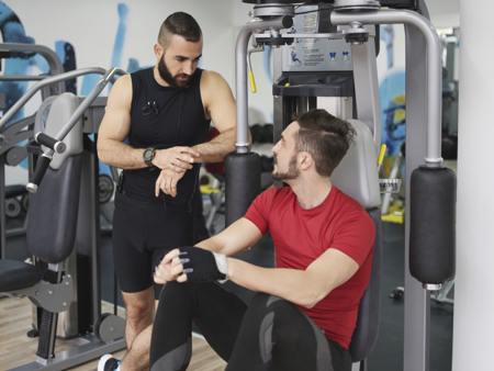Two men talking in gym