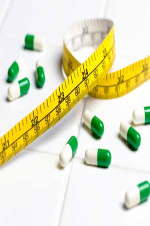 diet pills and measuring tape