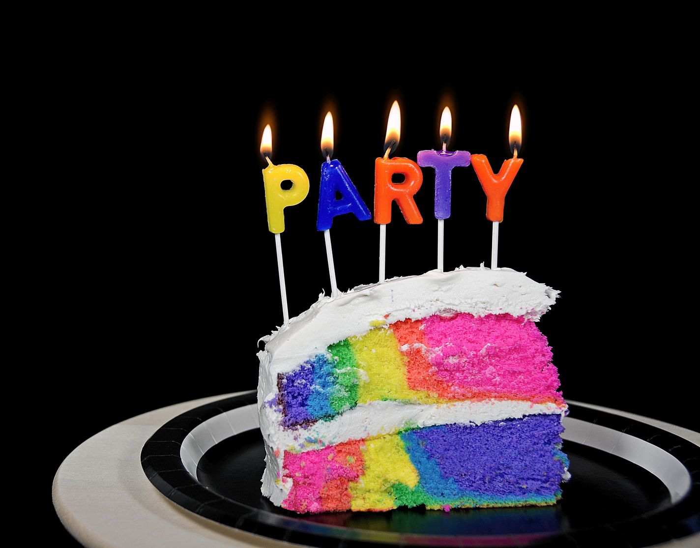 rainbow birthday cake with party candles