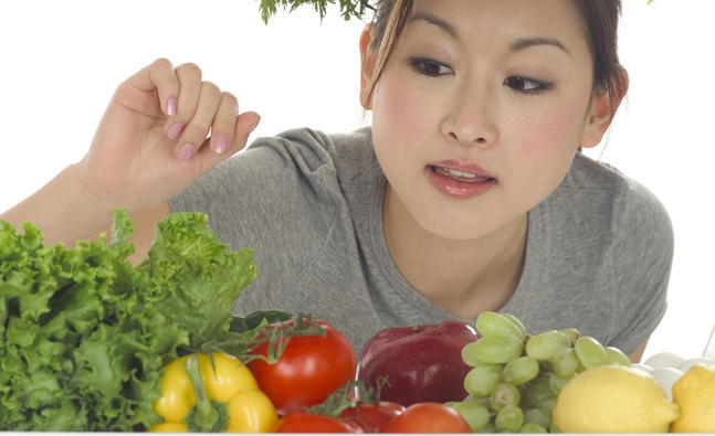 Woman Looking at Vegetables in Refrigerator