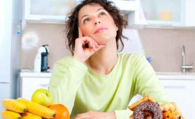 woman_pondering_which_dessert_to_eat_325495676_detail.jpg